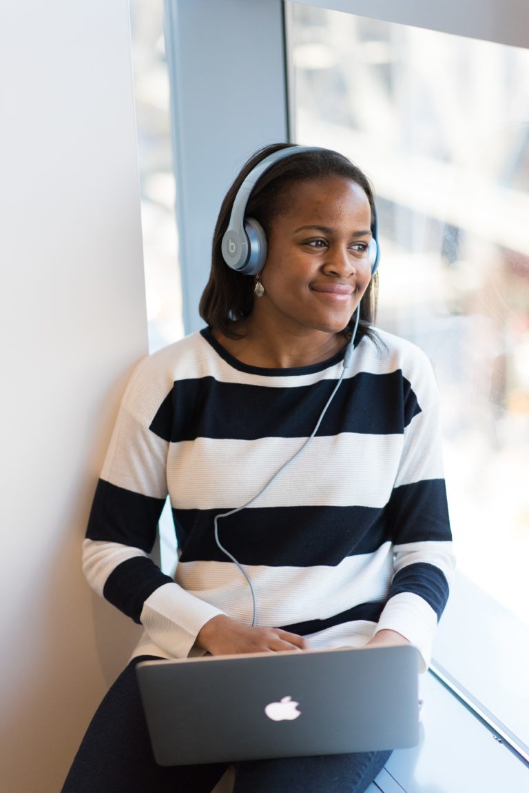 Protect Your Hearing While Wearing Headphones Woman wearing headphones looking out a window