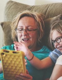 Woman and child looking at phone