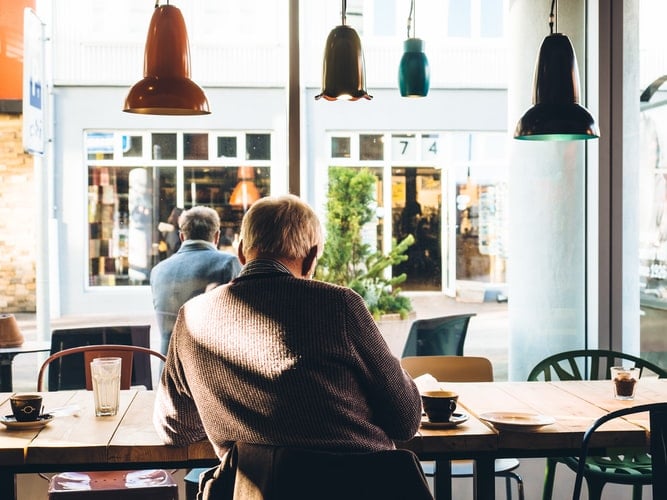 Man sits inside coffee shop