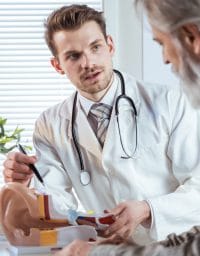 Audiologist talking to patient about hearing loss treatment options.