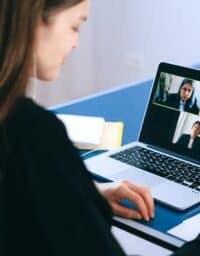 Woman attending a virtual work meeting on her laptop.