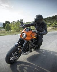 Man riding a motorcycle on an open road.