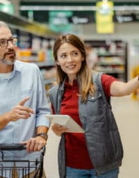 Woman helps man grocery shop