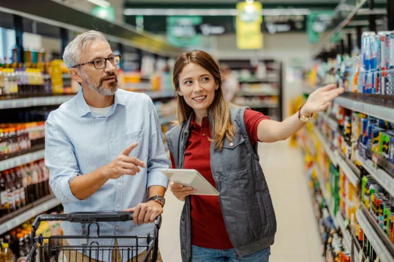 Woman helps man grocery shop