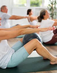 Woman using a medicine ball in yoga class
