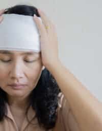 Woman with a head injury holding her head