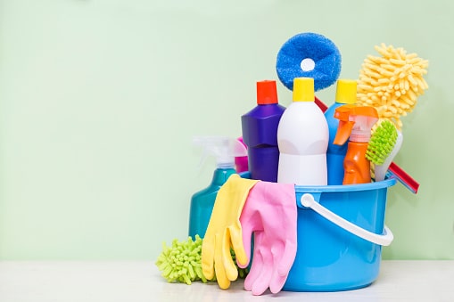 Cleaning Products House cleaning products on table with green background