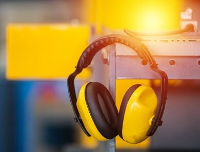 Soundproof headphones for industry plants hanging on lathe in factory. 